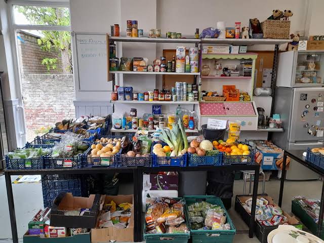 Picture of Bognor Regis community pantry with a table full of donated food.